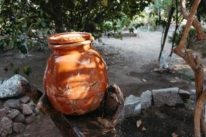 Clay water jug. Clay jug handmade isolated. Traditional pitcher. Old ceramic pot photo