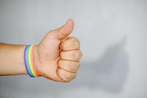 Man with gay bracelet on his hand, fighting for lgbt rights photo