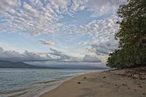 Sunset on turquoise tropical paradise island beach photo