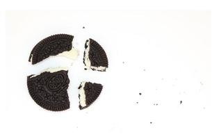 Sandwich chocolate cookies with a sweet cream with crumbs isolated on white background photo