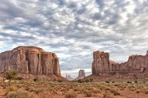Monument Valley view on cloudy sky background photo