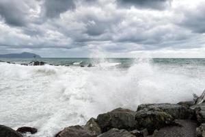 sea in tempest on rocks shore photo