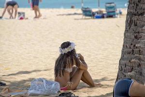 HONOLULU, USA - Beautiful girl relaxing on Waikiki beach photo