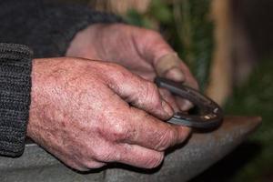 old retired man hands working photo