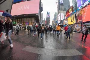 NEW YORK - USA  APRIL 22 2017 times square moving people in rainy day photo
