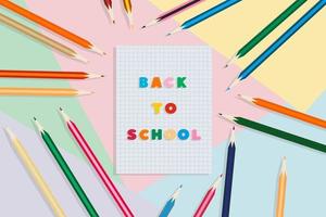 De vuelta a la escuela. cuaderno escolar y lápices, sobre un fondo multicolor. concepto de educación vector