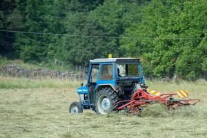 Tractor while harvesting mature wheat photo