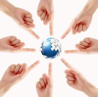 Conceptual symbol of a green Earth globe with multiracial human hands photo