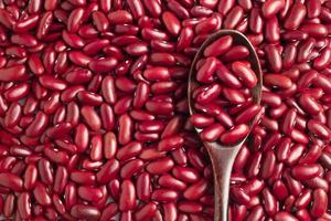 Close-up photo of several red kidney beans  and wooden spoon,top view,flay lay,top-down.