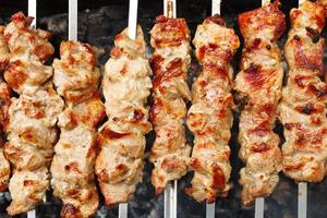 skewers with meat shish kebabs on brazier photo