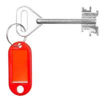 big door key with red blank key chain isolated photo