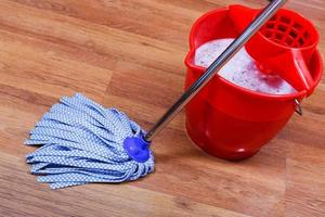 blue textile mop and red bucket photo