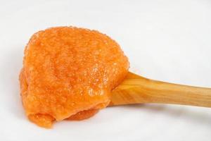 salty caviar of common carp in wooden spoon photo
