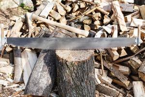 two-handled saw and cleaver in chopping bloc photo