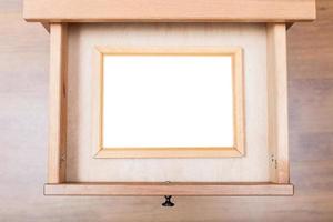 narrow picture frame in open drawer photo