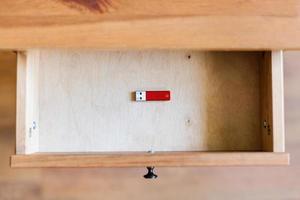 little red flash drive in open drawer photo