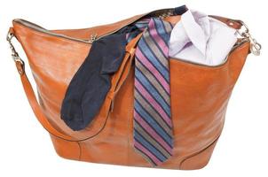 leather handbag with shirt, tie, sock isolated photo