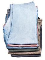 top view of stack of various jeans and corduroys photo