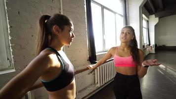 Fitness girls motivate each other in workout session video
