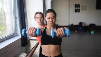 Fitness girls motivate each other in workout session video