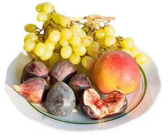 Crimean autumn seasonal fruits on plate isolated photo