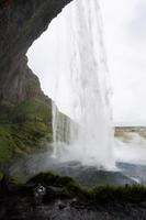 wet path in cave of Seljalandsfoss waterfall photo