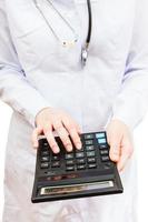 physician calculates the cost of treatment photo