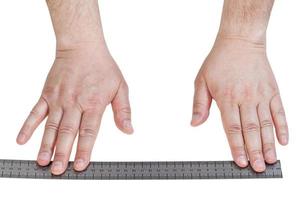 male hands with metallic ruler line isolated photo