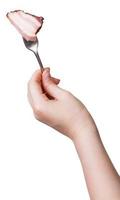 hand holding dinning fork with piece of bacon photo