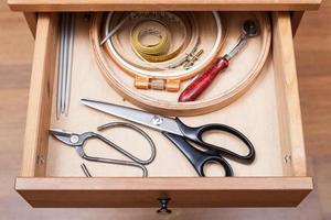 accessories for needlework in open drawer photo