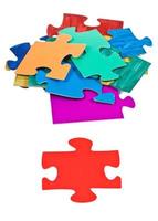 red piece near pile of jigsaw puzzles photo