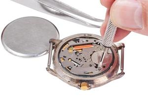 watchmaker replaces battery in watch isolated photo