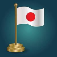 Japan national flag on golden pole on gradation isolated dark background. table flag, vector illustration