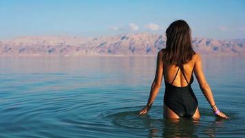 Beautiful woman swimming in the dead sea video