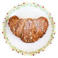 top view of croissant filled by chocolate on plate photo