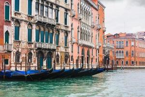 gondolas near houses in Venice in rain photo