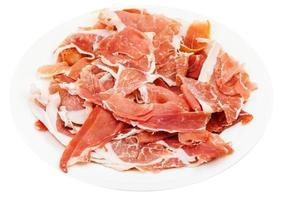 thin sliced dry-cured ham on white plate isolated photo