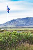 icelandic flag near Kerid Lake in Iceland photo