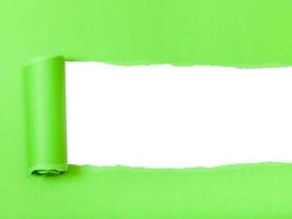 green rolled-up torn paper on white isolated photo