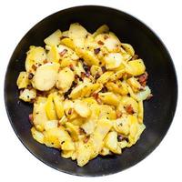 fried potatoes with pork cracklings in round pan photo
