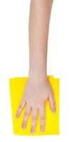 top view of hand with yellow cleaning rag isolated photo