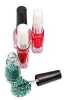 nail polish bottles and spilled green lacquer photo