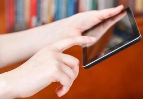 finger clicking touchpad screen in library photo