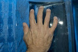 Hand on ice blocks wall photo