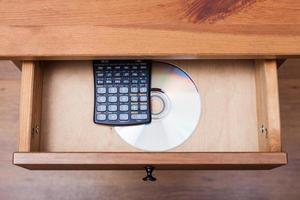 scientific calculator and disk in open drawer photo