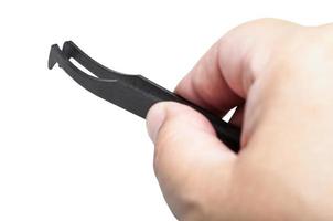 male hand with black plastic anti-static tweezers photo