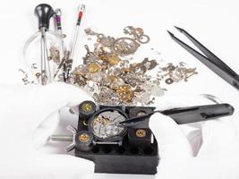 repair of mechanic wristwatch with spare parts photo