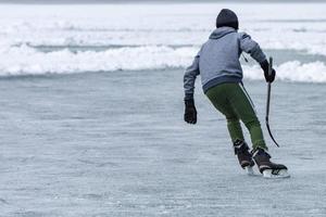 people playing hockey on frozen lake photo