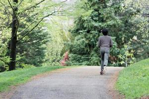 young boy using kick scooter photo