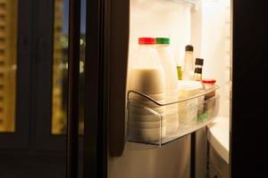 home fridge with dairy products in night photo